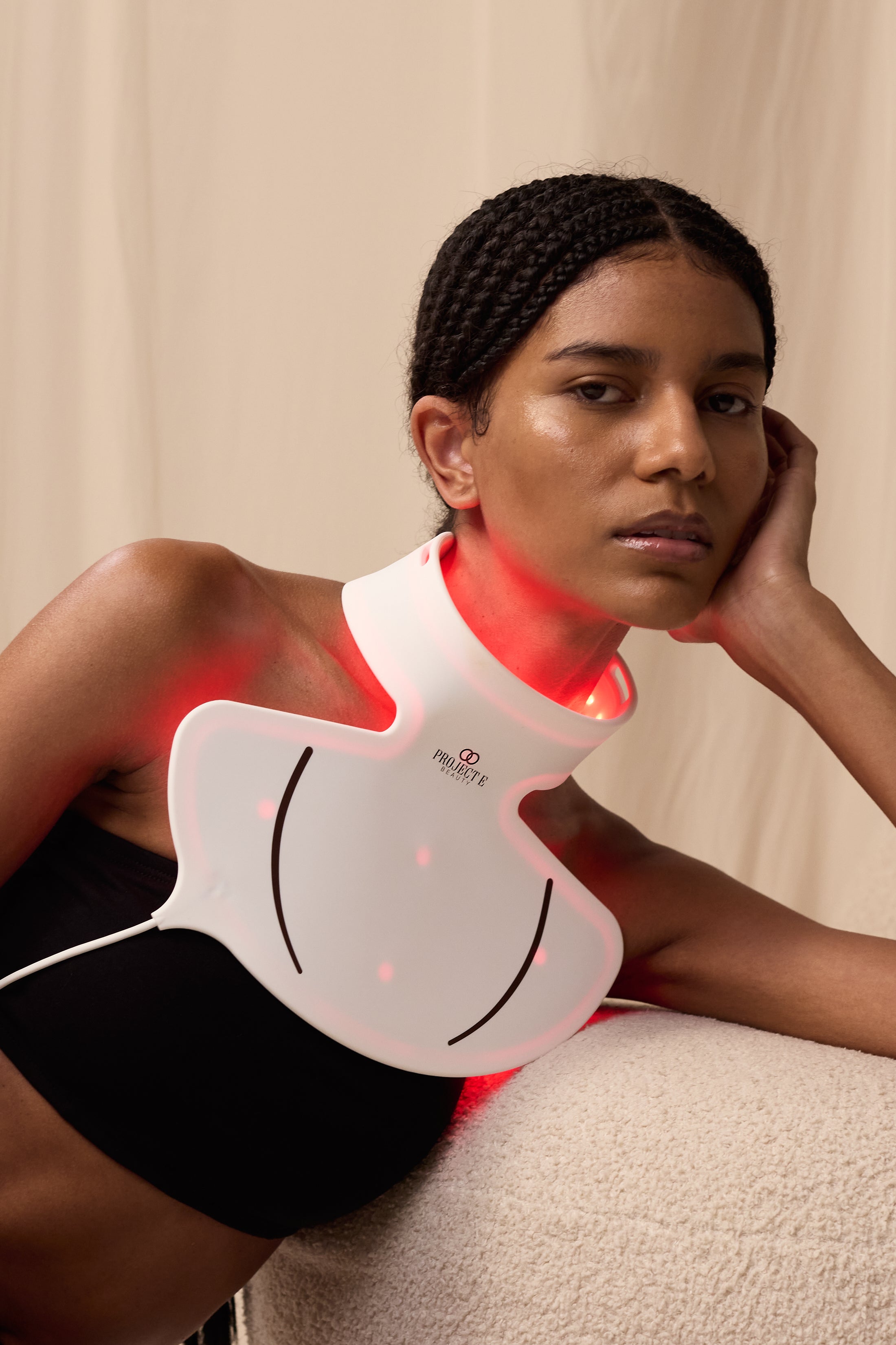 LumaLux Face+ face and neck LED mask showing a model wearing the neck attachment for skin rejuvenation
